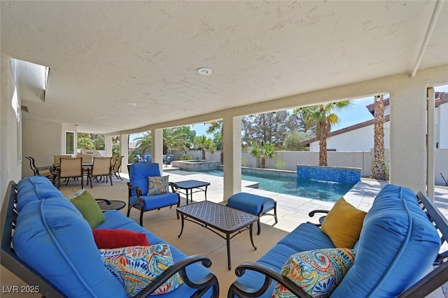 view of patio with outdoor dining area, a fenced backyard, outdoor lounge area, and a pool with connected hot tub