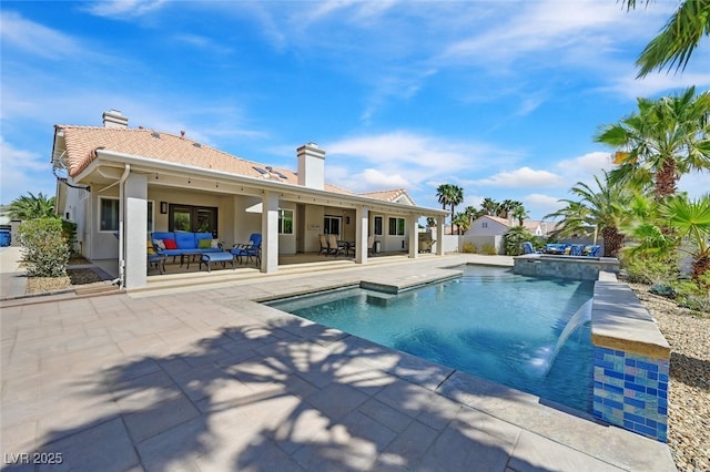 view of swimming pool featuring a pool with connected hot tub, an outdoor hangout area, and a patio area