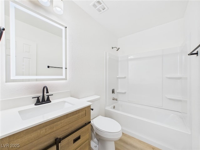 full bathroom featuring visible vents, bathtub / shower combination, wood finished floors, vanity, and toilet