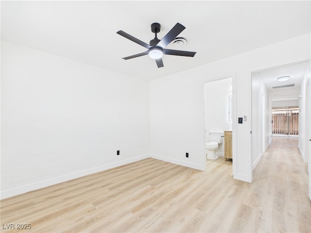 unfurnished bedroom featuring baseboards, connected bathroom, light wood finished floors, and visible vents