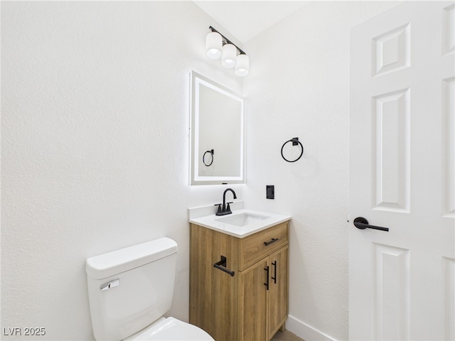 bathroom featuring toilet and vanity