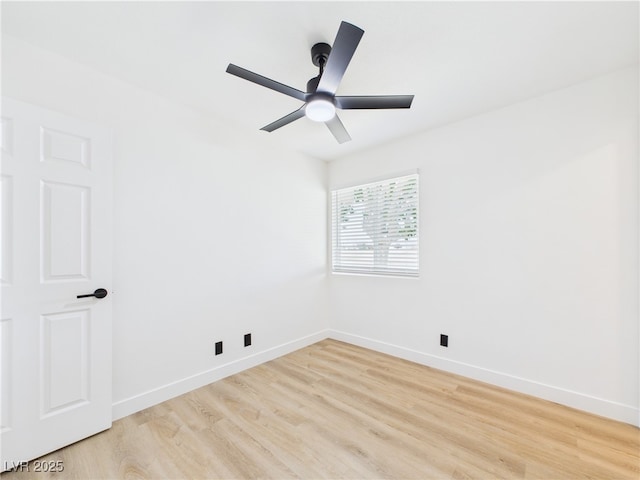 spare room with baseboards, light wood-style flooring, and ceiling fan