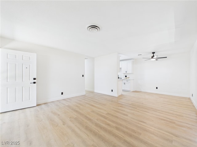 unfurnished living room featuring baseboards, a ceiling fan, light wood-type flooring, and visible vents
