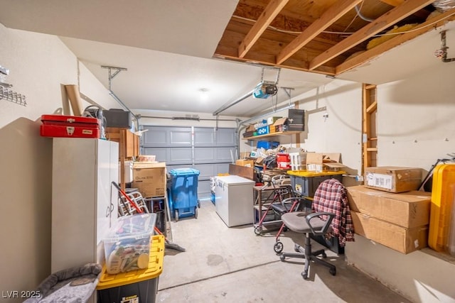 garage with a garage door opener and refrigerator