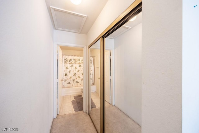 corridor featuring light colored carpet