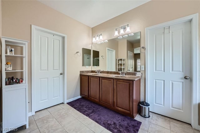 bathroom featuring double vanity, a sink, and tile patterned flooring