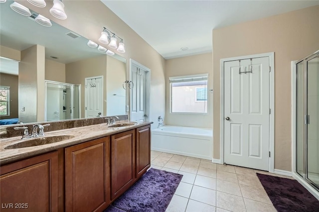 full bathroom with a sink, tile patterned floors, a stall shower, and visible vents