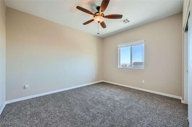 unfurnished room with visible vents, a ceiling fan, baseboards, and carpet floors