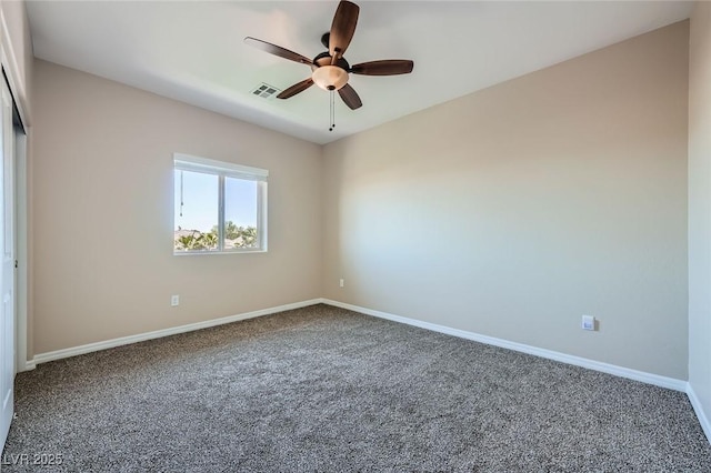 spare room with baseboards, ceiling fan, carpet, and visible vents