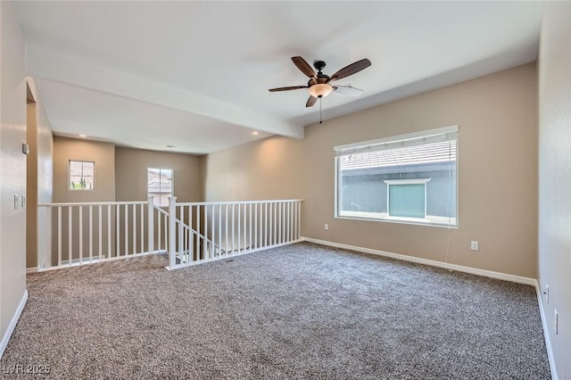 spare room featuring baseboards, a ceiling fan, and carpet flooring