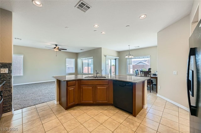 kitchen featuring visible vents, brown cabinets, a sink, black appliances, and light tile patterned flooring