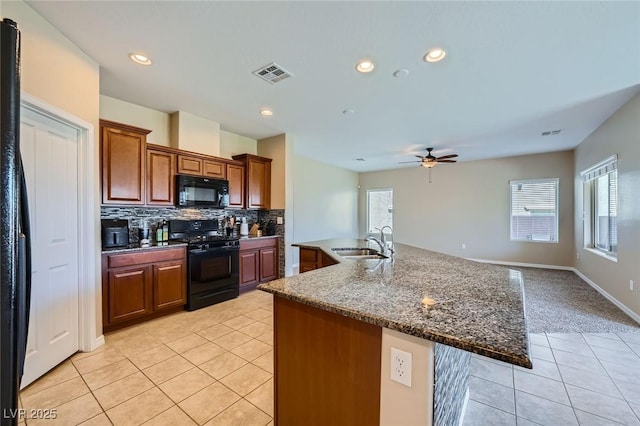 kitchen with visible vents, light tile patterned flooring, ceiling fan, a sink, and black appliances