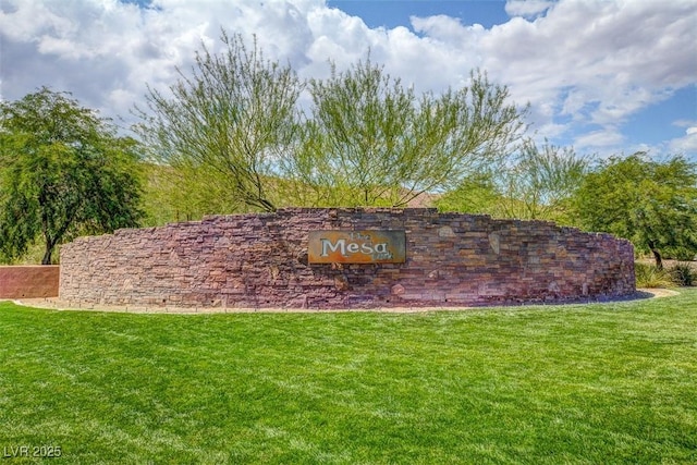 community / neighborhood sign with a yard