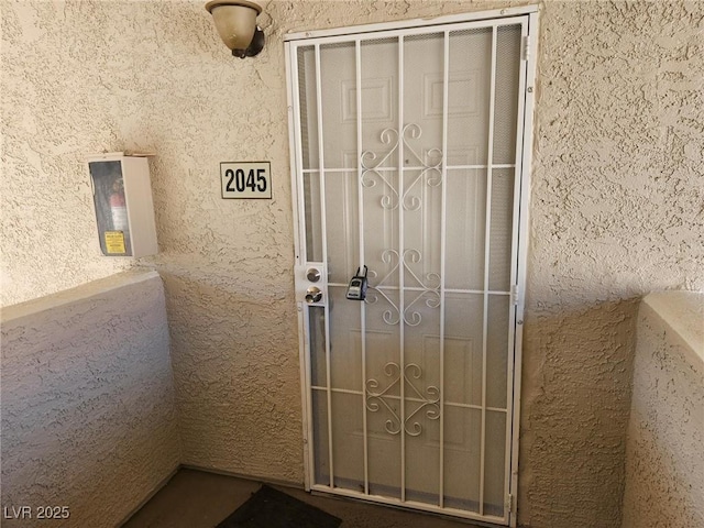 view of exterior entry with stucco siding