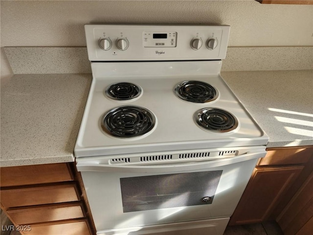 details featuring light countertops and white electric stove