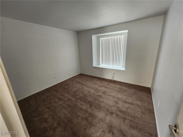 empty room featuring carpet floors and baseboards