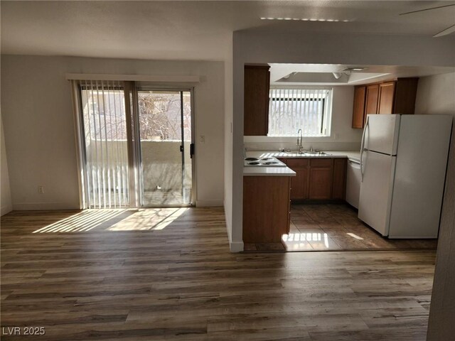 7300 Pirates Cove Rd Unit 2045, Las Vegas, NV 89145 - kitchen with freestanding refrigerator, dark wood-style floors, light countertops, brown cabinets, and a sink