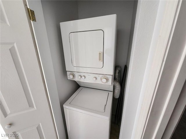 washroom with laundry area and stacked washer / dryer