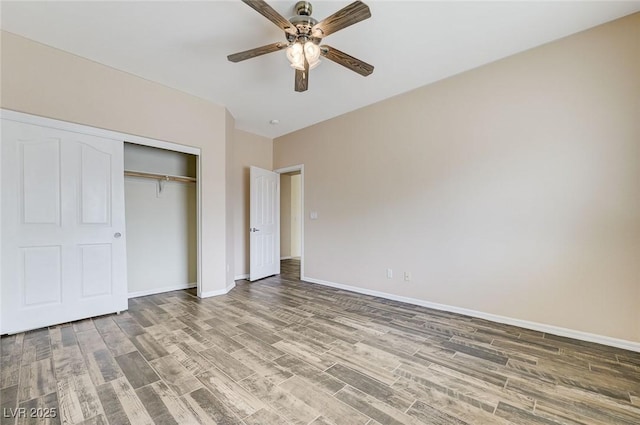 unfurnished bedroom featuring baseboards, a ceiling fan, a closet, and wood finished floors
