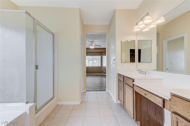 bathroom with vanity, a ceiling fan, tile patterned flooring, and a stall shower