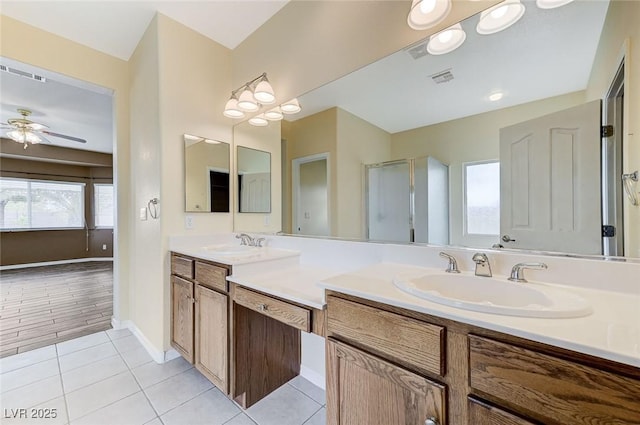 bathroom with a sink, ceiling fan, and visible vents