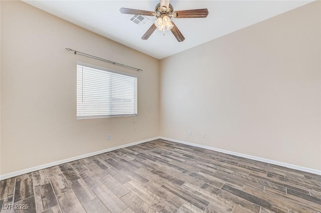 unfurnished room with baseboards, ceiling fan, wood finished floors, and visible vents