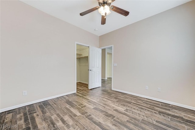empty room with baseboards, a ceiling fan, and wood finished floors