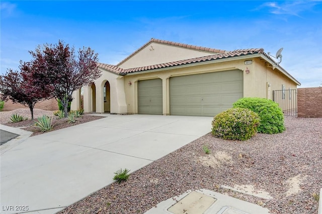 mediterranean / spanish-style house featuring a garage, stucco siding, driveway, and a tiled roof