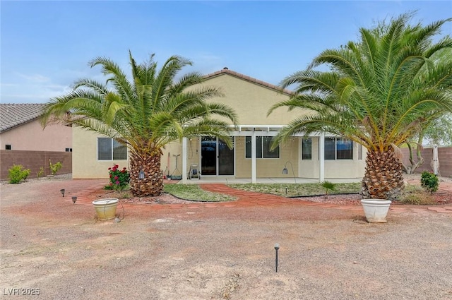 view of front of property featuring fence and stucco siding