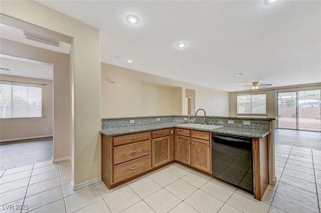 kitchen with visible vents, a ceiling fan, light tile patterned flooring, black dishwasher, and a sink