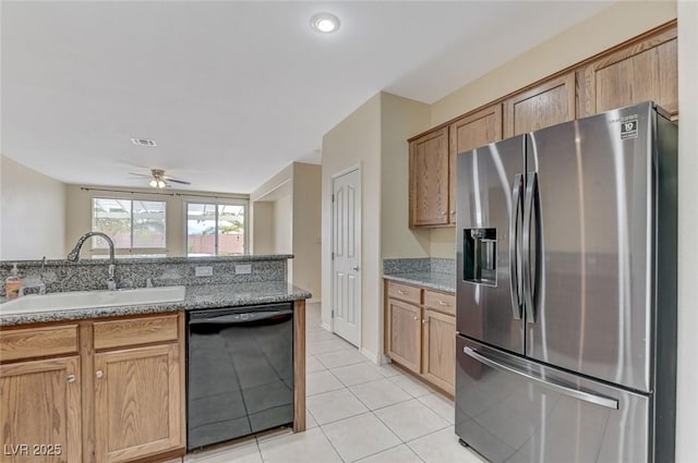 kitchen featuring a sink, dishwasher, light tile patterned floors, stainless steel refrigerator with ice dispenser, and visible vents