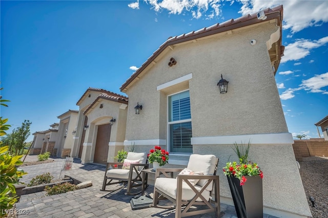 6325 Gambetta St, Las Vegas, NV 89115 - back of house featuring a patio, stucco siding, and a tiled roof