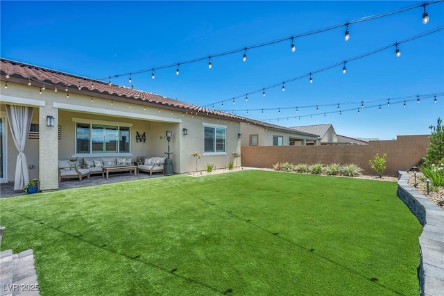 6325 Gambetta St, Las Vegas, NV 89115 - rear view of house with a yard, fence, an outdoor living space, and stucco siding