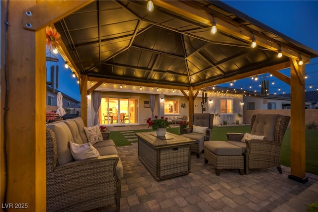 6325 Gambetta St, Las Vegas, NV 89115 - patio at twilight with a gazebo and an outdoor hangout area