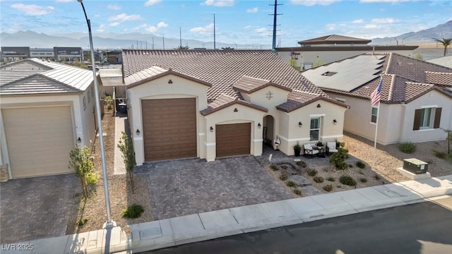6325 Gambetta St, Las Vegas, NV 89115 - mediterranean / spanish home with a garage, a mountain view, stucco siding, and a tiled roof