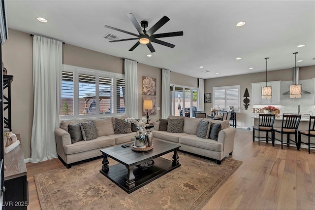 6325 Gambetta St, Las Vegas, NV 89115 - living room with recessed lighting, ceiling fan, visible vents, and light wood-type flooring