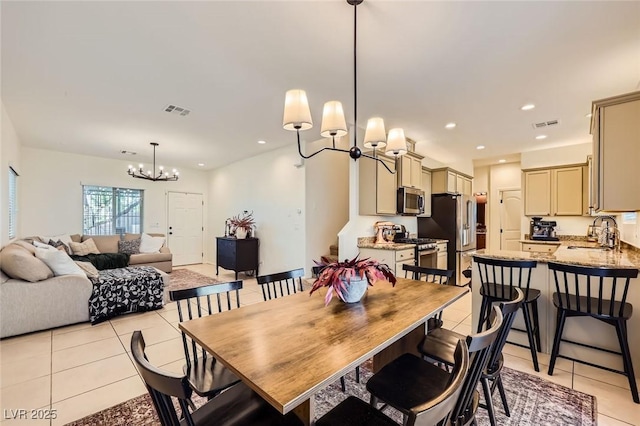 8091 Mosaic Sunrise Ln, Las Vegas, NV 89166 - dining space with a chandelier, light tile patterned floors, and recessed lighting