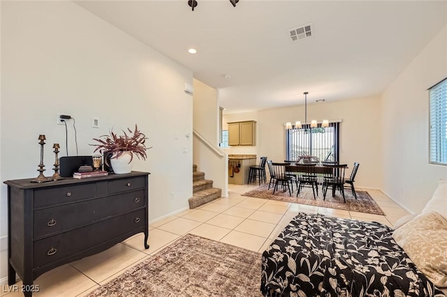 8091 Mosaic Sunrise Ln, Las Vegas, NV 89166 - living room with light tile patterned flooring, a chandelier, and stairway