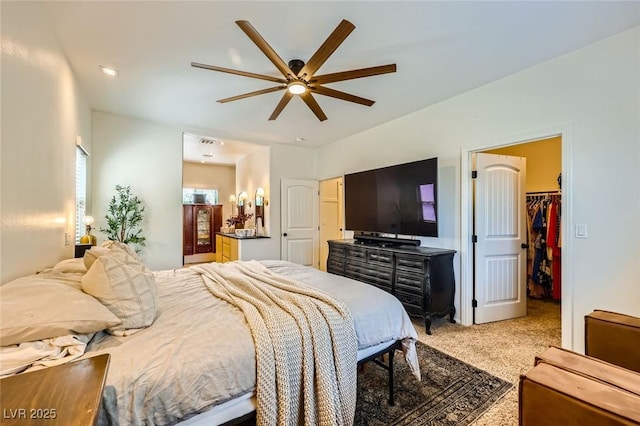 8091 Mosaic Sunrise Ln, Las Vegas, NV 89166 - bedroom featuring a walk in closet, carpet, connected bathroom, a ceiling fan, and a closet