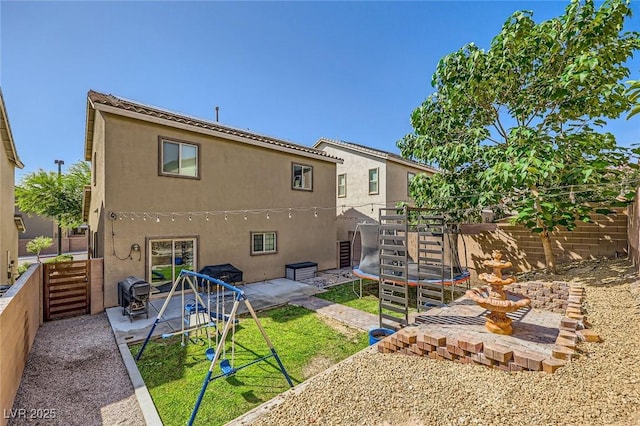 8091 Mosaic Sunrise Ln, Las Vegas, NV 89166 - back of property featuring a fenced backyard, a patio, and stucco siding