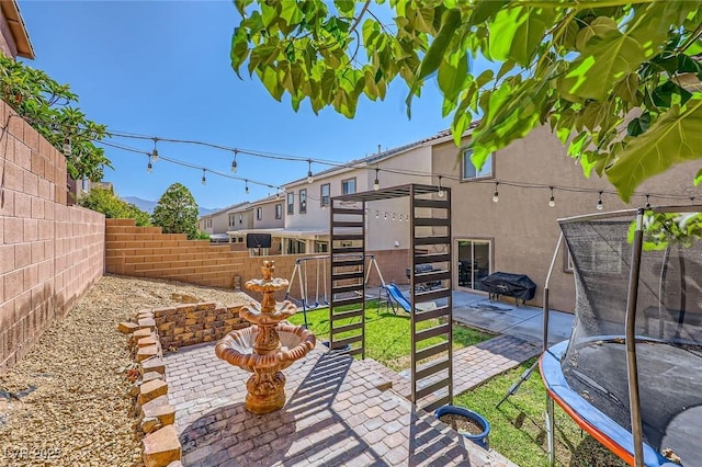 8091 Mosaic Sunrise Ln, Las Vegas, NV 89166 - fenced backyard featuring a patio area and a trampoline