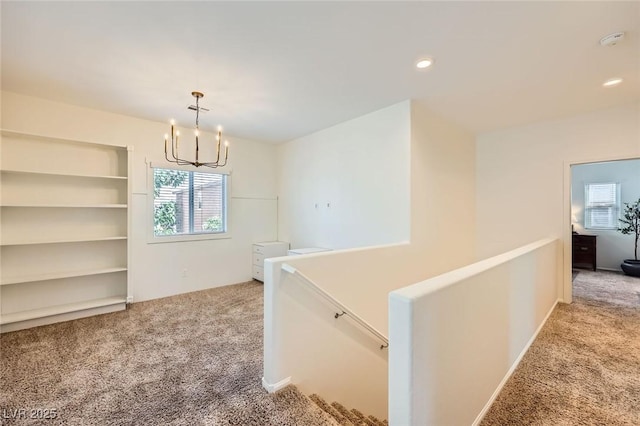 8091 Mosaic Sunrise Ln, Las Vegas, NV 89166 - corridor with light colored carpet, an upstairs landing, a chandelier, and recessed lighting