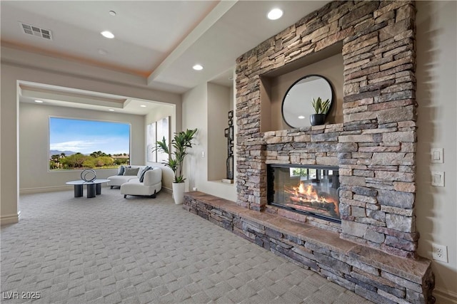 carpeted living area featuring baseboards, a fireplace, recessed lighting, and visible vents