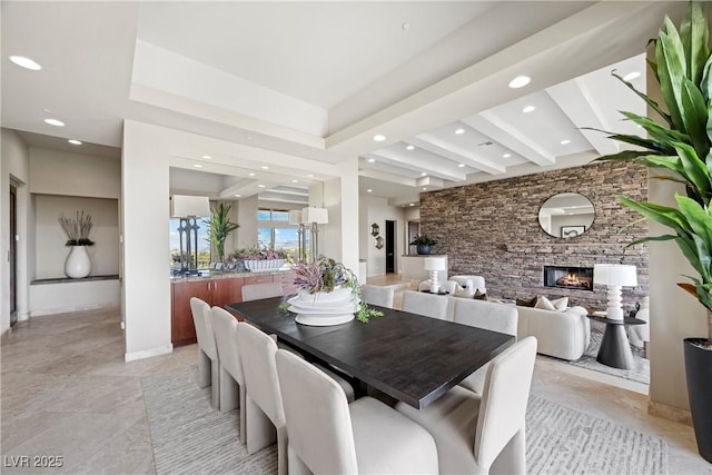 dining space with recessed lighting and a fireplace