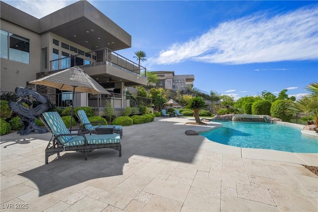 view of pool featuring a patio and a pool with connected hot tub