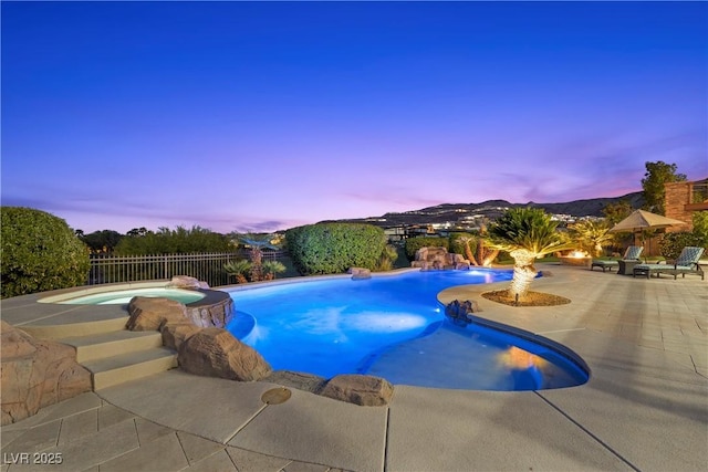 view of pool with a fenced backyard, a patio, and a pool with connected hot tub