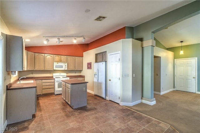 kitchen featuring visible vents, a center island, a sink, lofted ceiling, and white appliances