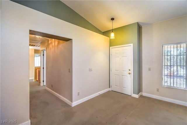 foyer entrance with carpet flooring, baseboards, and vaulted ceiling