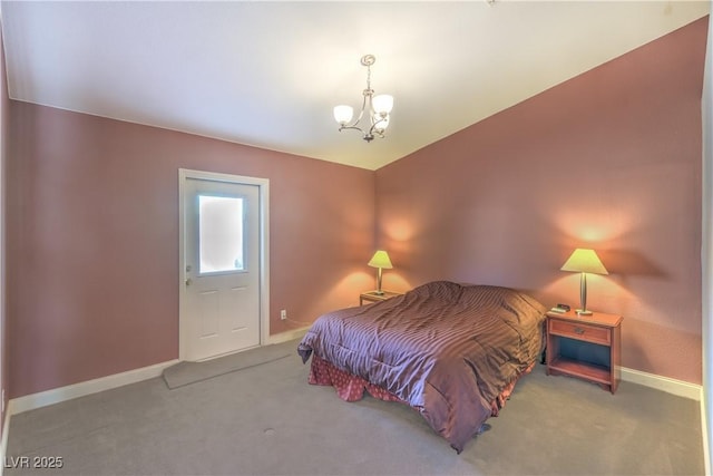 carpeted bedroom with baseboards and an inviting chandelier