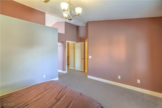 unfurnished bedroom with carpet flooring, baseboards, a notable chandelier, and vaulted ceiling